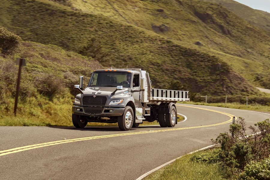 eMV Series driving on winding road through hills