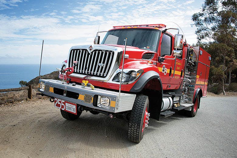 A red truck on a dirt road
