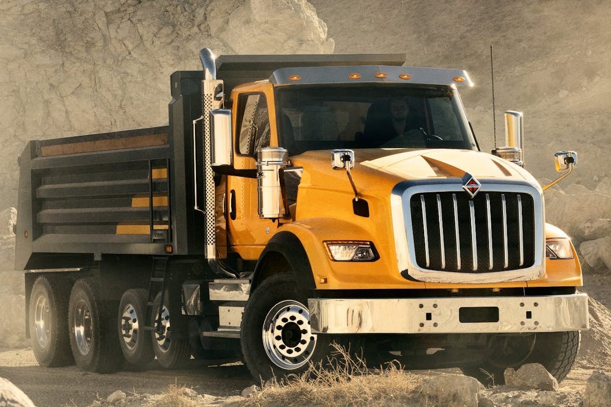 A yellow truck on a dirt road