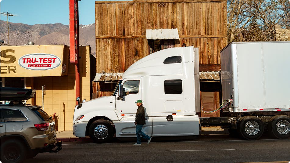 A person walking next to a truck