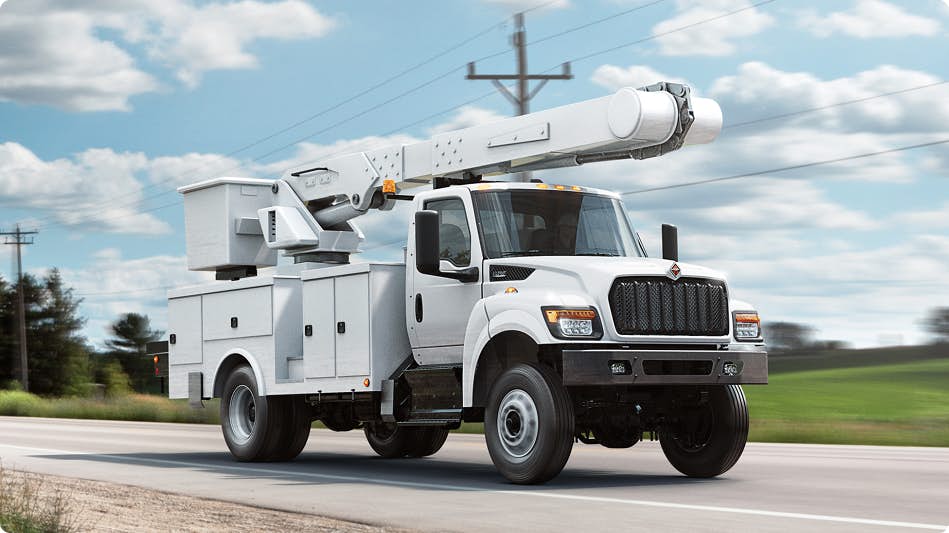 A white truck driving on the road