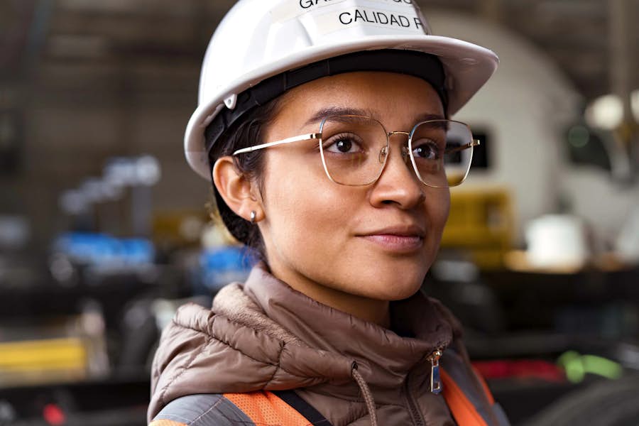 A person wearing a hard hat and glasses
