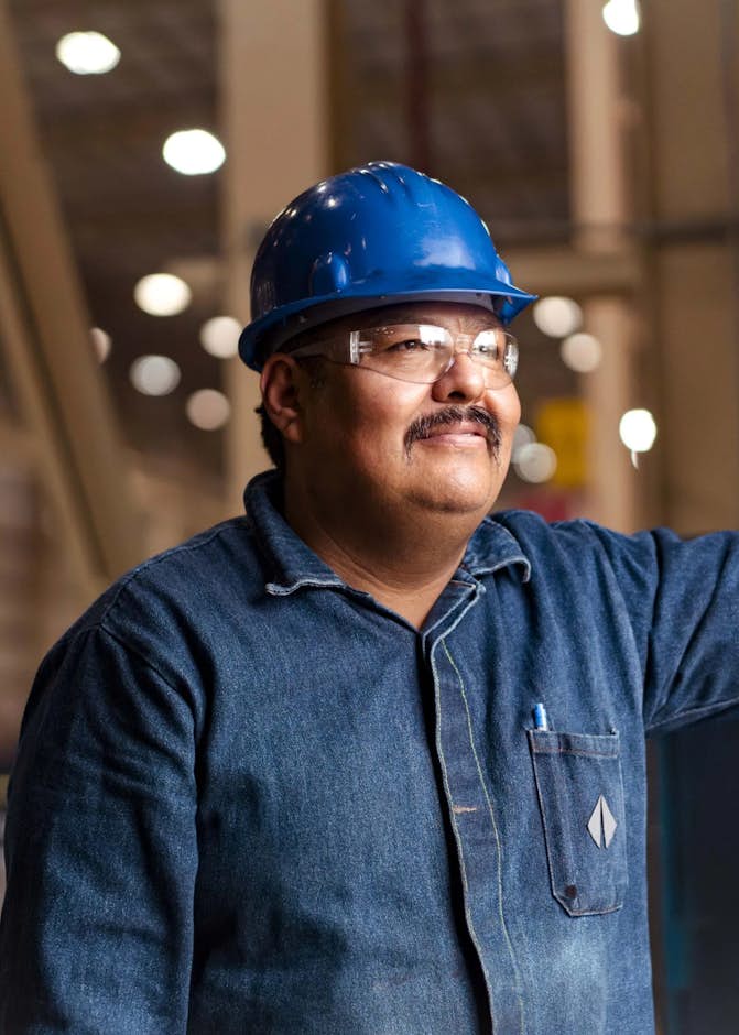 A person wearing a hard hat and glasses