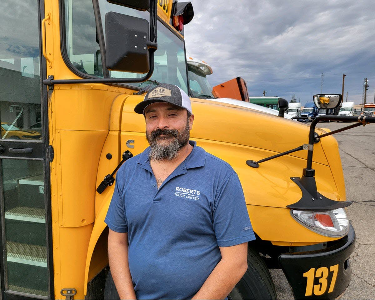 International dealer service advisor in front of bus