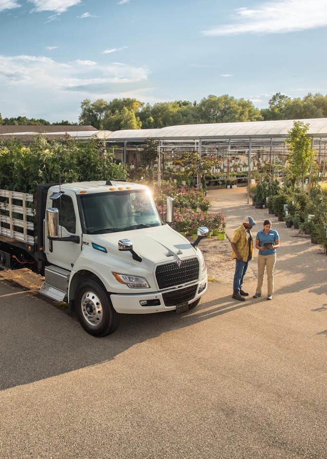 A truck with a bed of plants on it