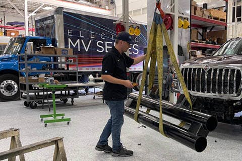 A person holding a metal pipe