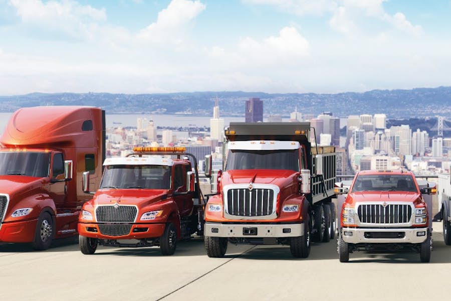 A group of trucks parked on a road