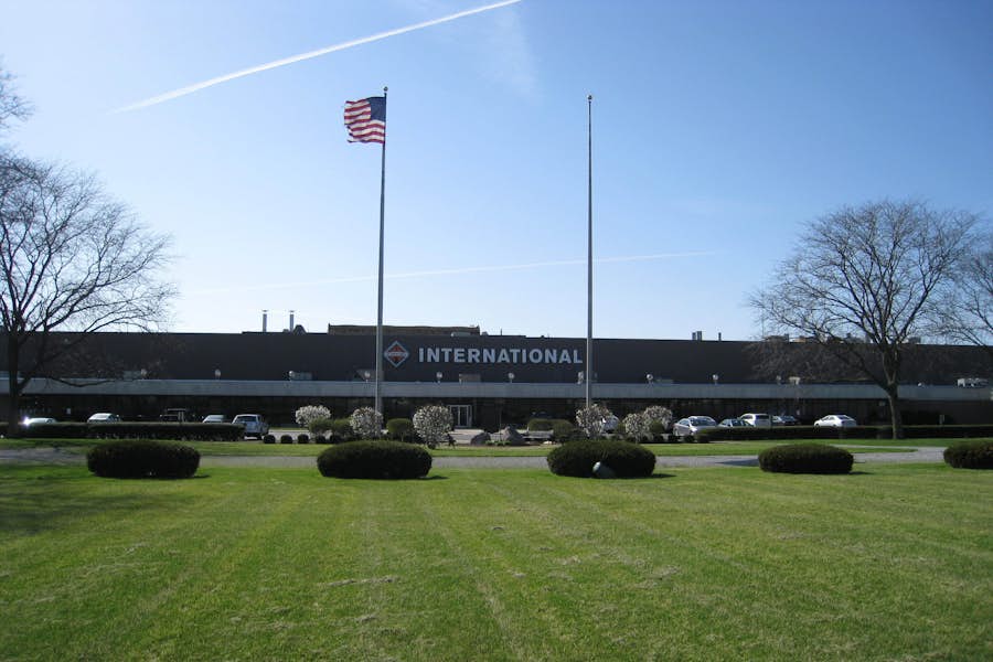 A flag on a flagpole in front of a building