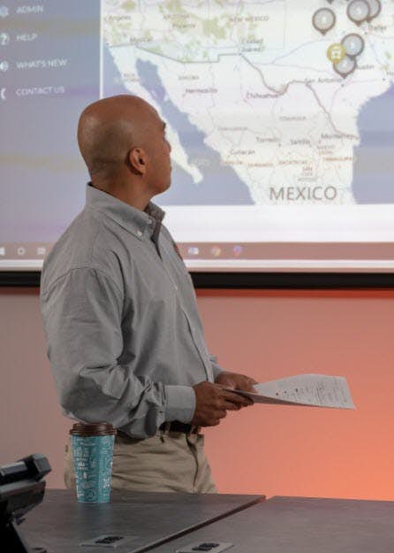 A person and person looking at a projection screen