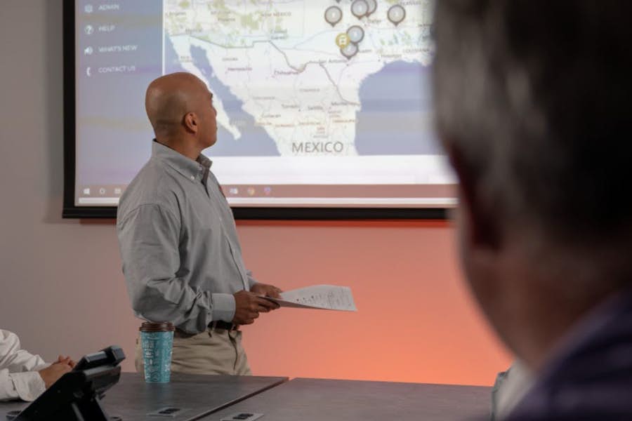 A person and person looking at a projection screen